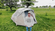 a man standing in front of a tent that says parkside