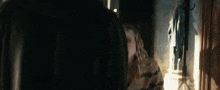 a man and a woman are looking at each other in front of a mirror