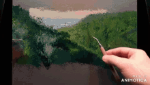 a hand is holding a brush in front of a painting that says made in animotica