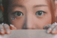 a close up of a woman 's eyes with rhinestones on her face .