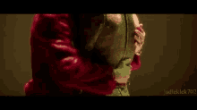 a woman in a red fur coat is holding her breasts