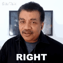 a man wearing headphones says right in front of a picture