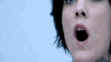 a close up of a woman 's face with a surprised look on her face .
