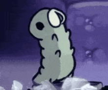 a cartoon worm is standing on a pile of tissues .