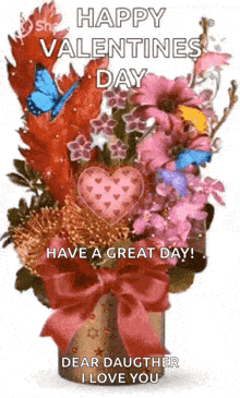 a bouquet of flowers in a vase with a bow and hearts on them .