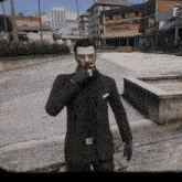 a man in a black suit smoking a cigarette in front of a bean machine