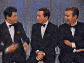 three men wearing tuxedos and bow ties are standing next to each other