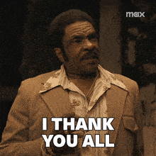 a man in a suit holds a glass and says " i thank you all "