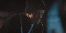 a man wearing a beanie and headphones looks at something