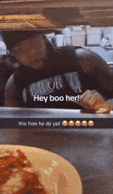 a man wearing a shirt that says hey boo her is standing in front of a plate of food