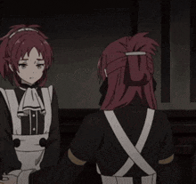 a couple of anime girls are standing next to each other .