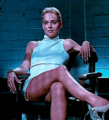 a woman sitting in a chair with her legs crossed