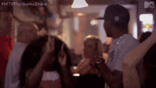 a group of people are dancing at a party in a club .
