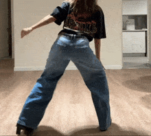 a woman wearing a black t-shirt that says ' nirvana ' on it is dancing