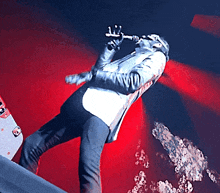 a man singing into a microphone while standing on a stage