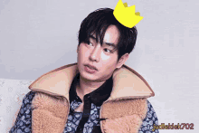 a man with a yellow crown on his head with judleklek702 written on the bottom right