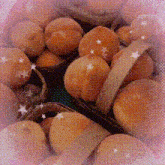 a bunch of peaches in a basket with a pink background