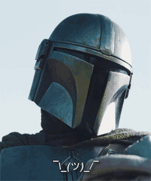 a close up of a man wearing a helmet with a smiley face on the bottom