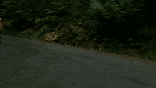 a black volvo car is parked on the side of a road