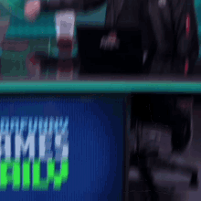 a blurry picture of a man behind a desk with a laptop that says ninja on it