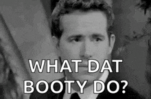 a black and white photo of a man in a suit and tie asking what dat booty do .