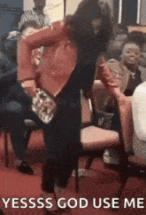 a woman in a red jacket is dancing in front of a crowd of people .