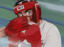 a man wearing red boxing gloves and a helmet with the letter vii on it