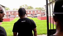 a man wearing a black t-shirt that says 7eleven