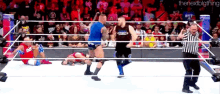 a wrestling match is going on in front of a crowd and the next big thing is written on the bottom