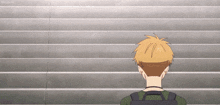 a man with a backpack is standing in front of a set of stairs .