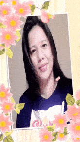 a woman is surrounded by pink flowers and has a shirt that says quail on it