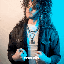 a man with long curly hair is wearing sunglasses and a black jacket with the word mcdh on the bottom
