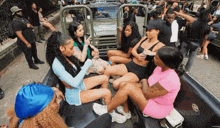 a group of women are sitting in the back of a truck with the word reusd on the bottom right
