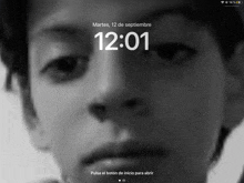 a black and white photo of a man 's face with the time 12:01