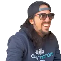 a man wearing sunglasses and a ebay motors sweatshirt smiles