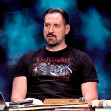 a man wearing a t-shirt that says the mighty on it