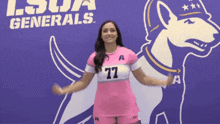 a woman in a pink shirt with 77 on it