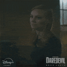 a poster for daredevil born again shows a woman in a black dress