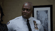 a man in a police uniform with a name tag that says ' wolf ' on it