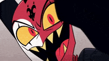 a close up of a cartoon character 's face with sharp teeth and big red eyes .