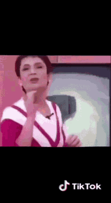a tiktok video of a woman with a microphone on her neck