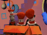 a cat in the hat is wearing boxing gloves with the letter b on them