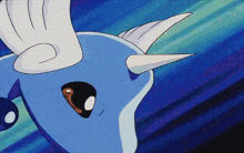 a close up of a blue cartoon character with wings and horns