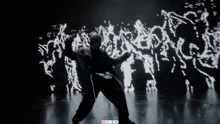 a man in a suit is dancing in front of a screen that says ' recording '