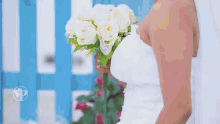a man in a tuxedo is standing next to a woman in a white dress