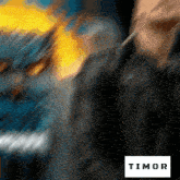 a blurred image of a person with the word timor on the bottom right