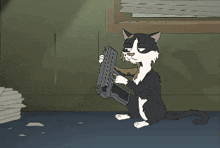 a black and white cat playing with a mouse