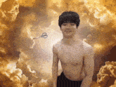 a shirtless man is smiling with a pair of scissors in the background