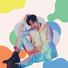 a man in a white suit is sitting on the floor