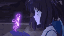 a girl with purple hair is holding a purple object in her hand